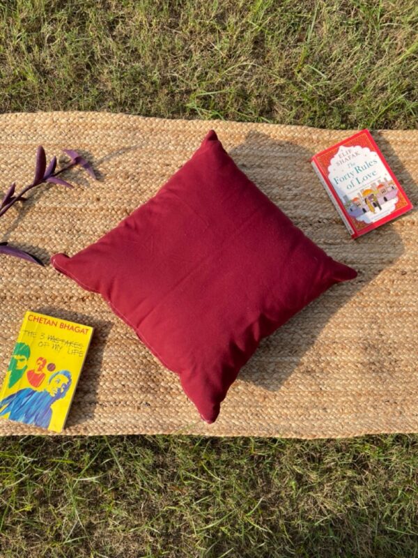 Upcycled cushion made from repurposed fabrics, eco-friendly and sustainable home décor accent piece.