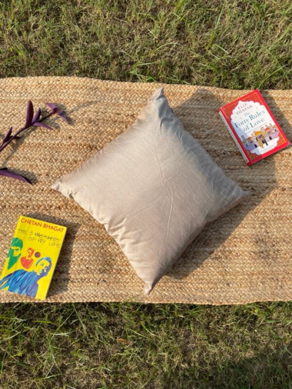 Upcycled cushion made from repurposed fabrics, eco-friendly and sustainable home décor accent piece.