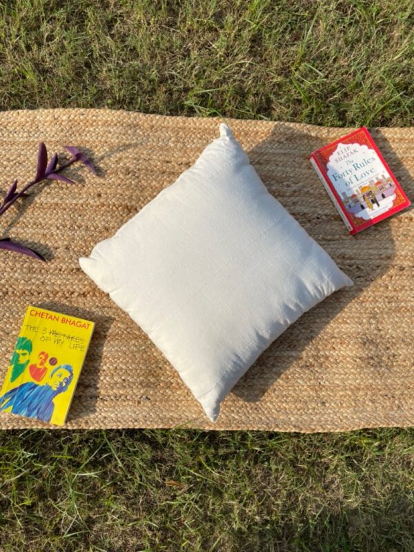 Upcycled cushion made from repurposed fabrics, eco-friendly and sustainable home décor accent piece.