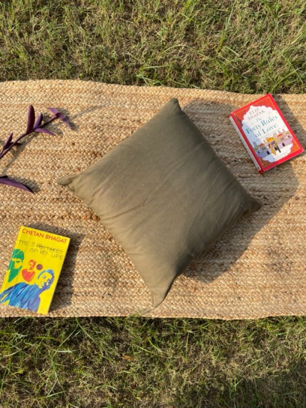 Upcycled cushion made from repurposed fabrics, eco-friendly and sustainable home décor accent piece.