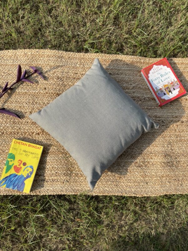 Upcycled cushion made from repurposed fabrics, eco-friendly and sustainable home décor accent piece.