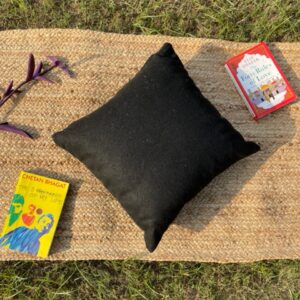 Upcycled cushion made from repurposed fabrics, eco-friendly and sustainable home décor accent piece.