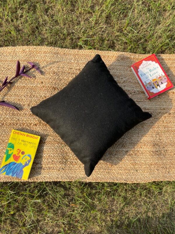 Upcycled cushion made from repurposed fabrics, eco-friendly and sustainable home décor accent piece.
