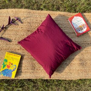 Upcycled cushion made from repurposed fabrics, eco-friendly and sustainable home décor accent piece.