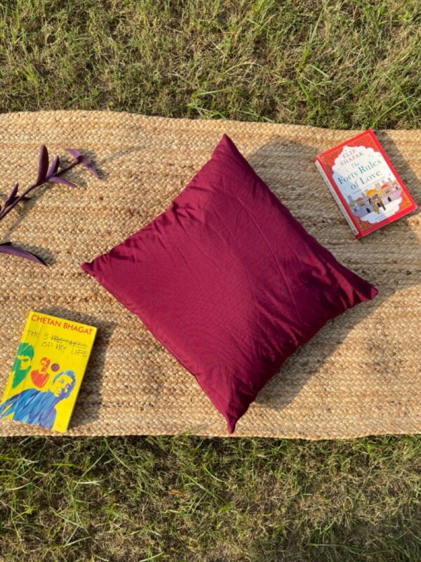 Upcycled cushion made from repurposed fabrics, eco-friendly and sustainable home décor accent piece.