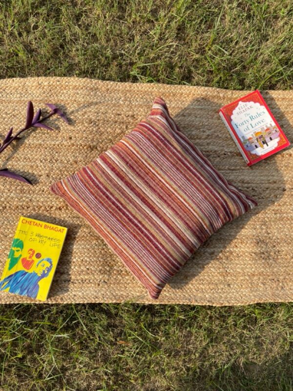 Upcycled cushion made from repurposed fabrics, eco-friendly and sustainable home décor accent piece.