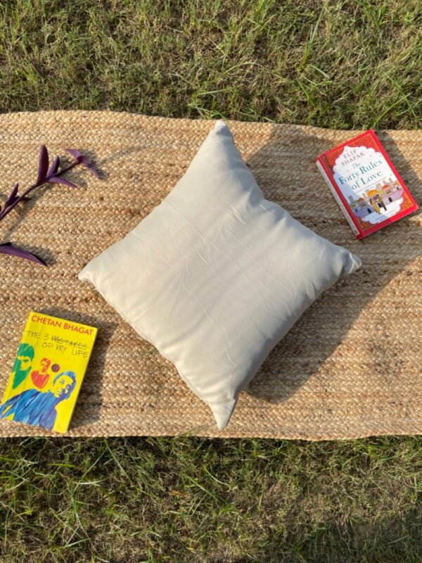 Upcycled cushion made from repurposed fabrics, eco-friendly and sustainable home décor accent piece.