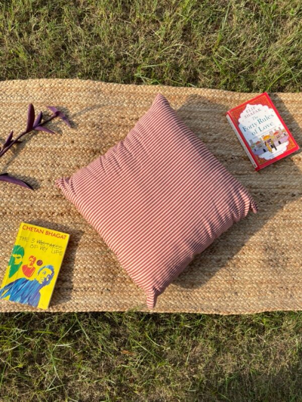 Upcycled cushion made from repurposed fabrics, eco-friendly and sustainable home décor accent piece.