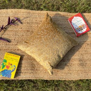 Upcycled cushion made from repurposed fabrics, eco-friendly and sustainable home décor accent piece.