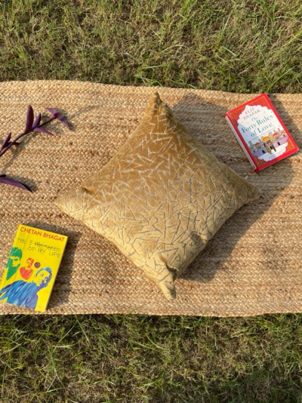 Upcycled cushion made from repurposed fabrics, eco-friendly and sustainable home décor accent piece.