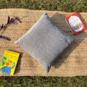 Upcycled cushion made from repurposed fabrics, eco-friendly and sustainable home décor accent piece.