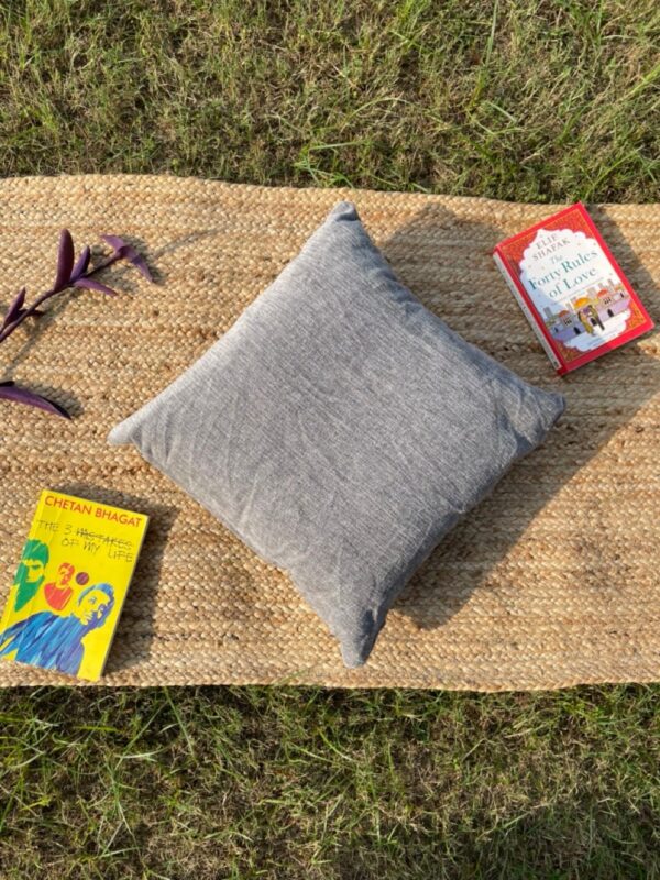 Upcycled cushion made from repurposed fabrics, eco-friendly and sustainable home décor accent piece.