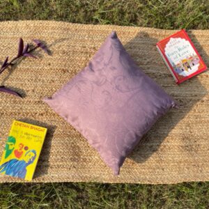 Upcycled cushion made from repurposed fabrics, eco-friendly and sustainable home décor accent piece.