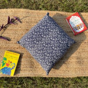 Upcycled cushion made from repurposed fabrics, eco-friendly and sustainable home décor accent piece.