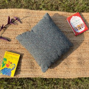 Upcycled cushion made from repurposed fabrics, eco-friendly and sustainable home décor accent piece.