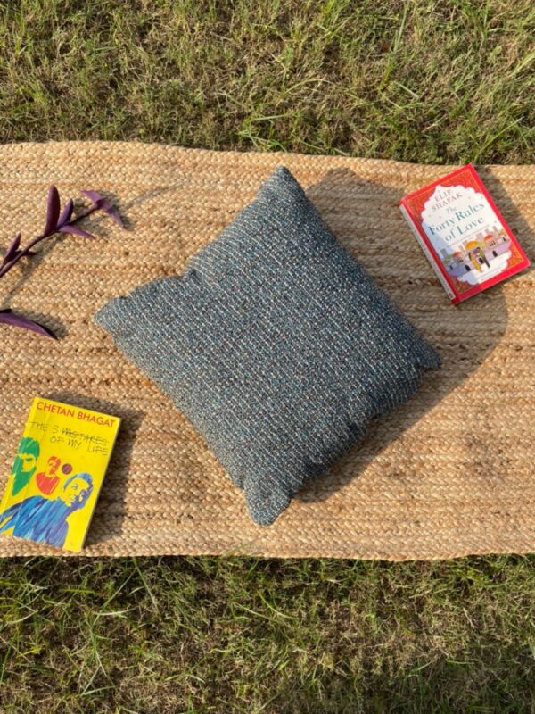 Upcycled cushion made from repurposed fabrics, eco-friendly and sustainable home décor accent piece.