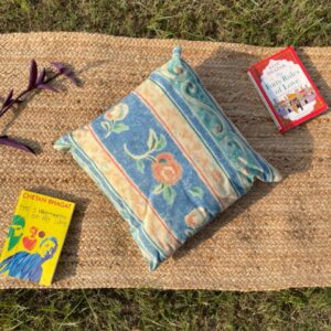 Upcycled cushion made from repurposed fabrics, eco-friendly and sustainable home décor accent piece.