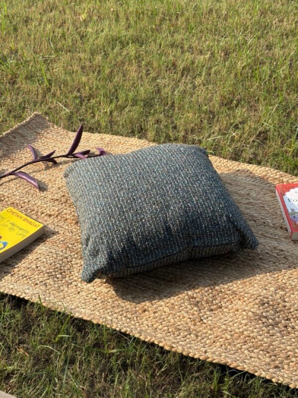 Upcycled cushion made from repurposed fabrics, eco-friendly and sustainable home décor accent piece.