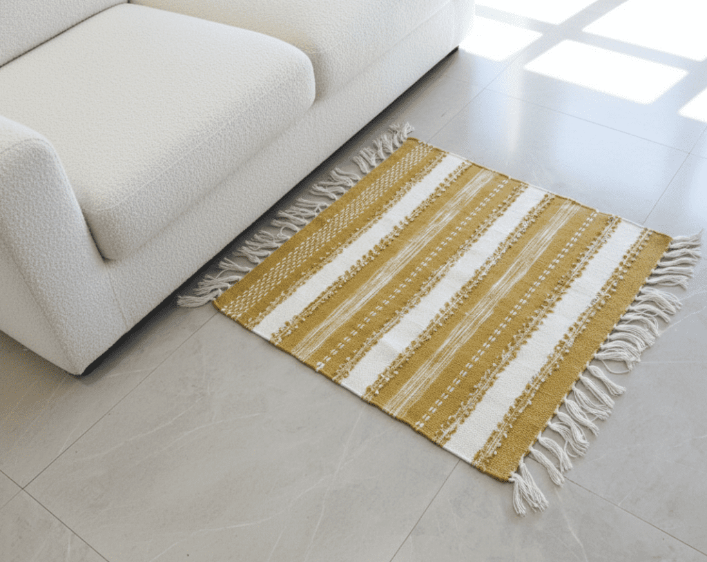 Handwoven sustainable floor mat by Respun made from recycled textiles, placed next to a bedside sofa, suitable for floor seating, bedside use, and decorative home decor.