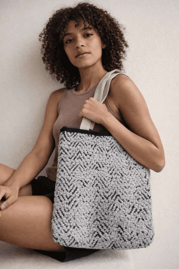 Upcycled tote bag made from recycled fabric, sturdy and spacious, suitable for college, shopping, and everyday use