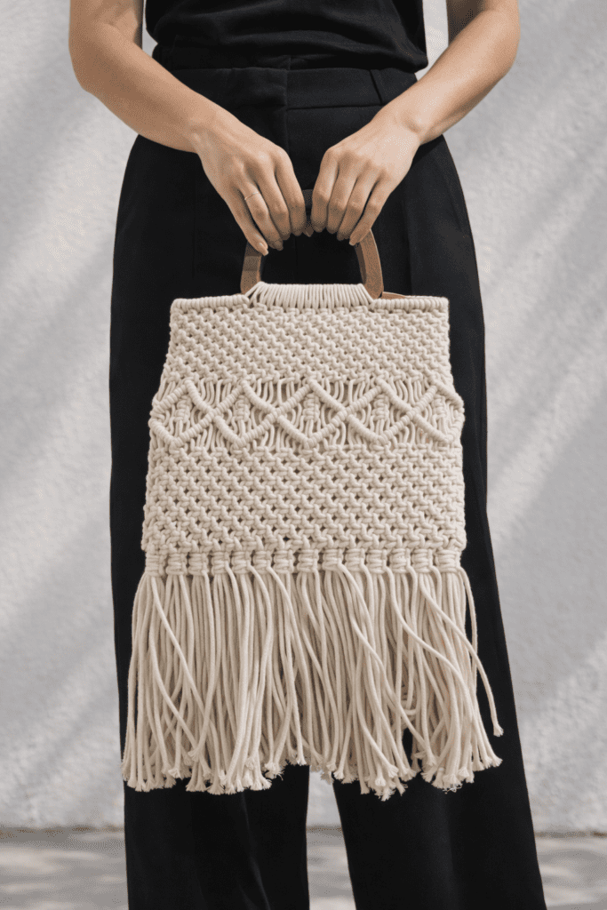 Natural crochet tote bag with wooden handles and fringe