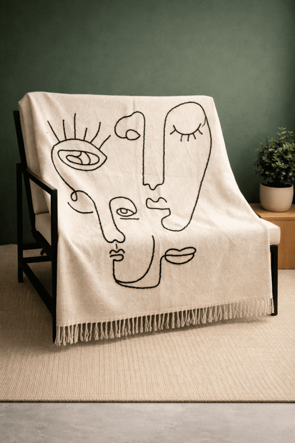 Handcrafted face decorative throw placed on a sofa